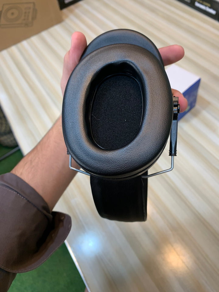  Close-up view of noise-cancelling ear muffs featuring padded ear cups and durable construction for maximum comfort and protection.